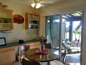a kitchen with a table with a vase of flowers on it at Unit 17 Large 1 Bed 1 Bath Condo Ocean Views in Pahala