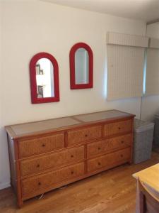 a dresser in a room with two mirrors on the wall at Unit 17 Large 1 Bed 1 Bath Condo Ocean Views in Pahala