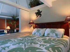 a bedroom with a bed and a large window at Unit 18 Relaxing Oceanview Studio in Pahala