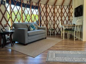 a living room with a couch and a table at Yurt BenTiki in Naalehu