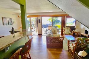 a kitchen and living room with a counter and chairs at 58 2 bedroom 2 bath in Pahala