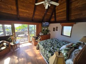 a bedroom with a bed and a ceiling fan at 58 2 bedroom 2 bath in Pahala