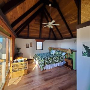 a bedroom with a bed and a ceiling fan at 58 2 bedroom 2 bath in Pahala +47 photos