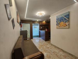 a kitchen and a living room with a counter top at Hotel Rio in Mumbai