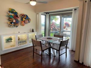 a dining room with a table and chairs and a window at 37 1 Bed 1 Bath with Ocean Views in Pahala +9 photos