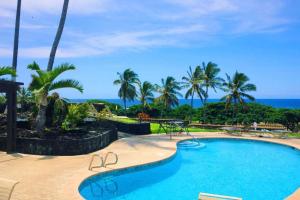 a swimming pool with the ocean in the background at 37 1 Bed 1 Bath with Ocean Views in Pahala