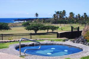 a hot tub with a metal rail in a yard at 37 1 Bed 1 Bath with Ocean Views in Pahala
