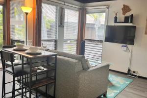 a living room with a couch and a table at 43 Studio Queen Bed in Pahala