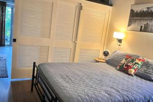 a bedroom with a bed and a wall of windows at 43 Studio Queen Bed in Pahala +27 photos
