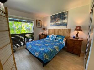 a bedroom with a bed and a window at 71 Dramatic Ocean and Lava in Pahala