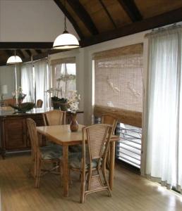 a dining room with a wooden table and chairs at 54 Old Hawaii Charm Condo in Pahala