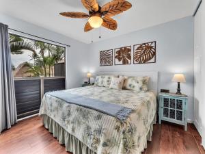 a bedroom with a bed and a ceiling fan at 57 Beautiful Remodeled Studio in Pahala