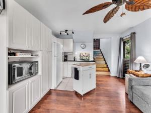 a kitchen with white cabinets and a counter top at 57 Beautiful Remodeled Studio in Pahala