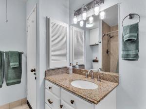 a bathroom with a sink and a shower with a mirror at 57 Beautiful Remodeled Studio in Pahala