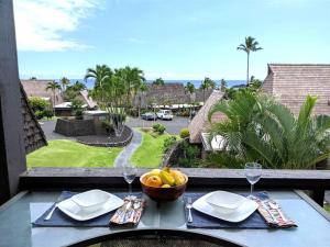 a table with a bowl of fruit on a balcony at 56 One Bedroom One Bath with Ocean Views in Pahala
