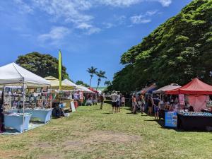 a group of tents and stalls at an outdoor market at 56 One Bedroom One Bath with Ocean Views in Pahala +9 photos