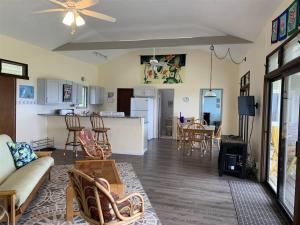 a living room and kitchen with a couch and a table at 2 Bedroom 2 Bath on Golf Course in Naalehu