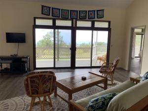 a living room with a couch and a table at 2 Bedroom 2 Bath on Golf Course in Naalehu