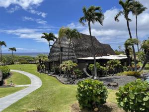 a resort with palm trees and a pathway at 16 Two Bedroom Two Bath Condo in Pahala