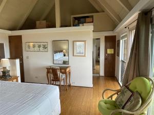 a bedroom with a bed and a table and chairs at 16 Two Bedroom Two Bath Condo in Pahala +29 photos