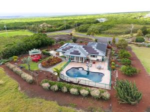 an aerial view of a house with a swimming pool at Honu Harbor with Pool on Golf Course in Naalehu