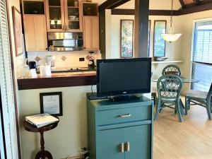 a tv on top of a blue cabinet in a kitchen at Unit 26 King Bed and Ocean View in Pahala +10 photos