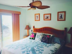 a bedroom with a bed and a ceiling fan at Unit 25 Hula Hut Best Value in Pahala