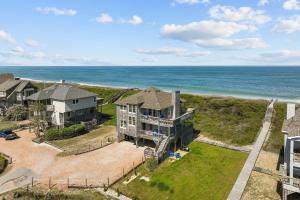 an aerial view of a house and the ocean at 2410 - Come Sail Away in Duck