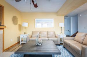 a living room with a couch and a table at 5195 - Captain's Choice in Kill Devil Hills +77 photos