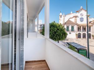 a balcony with a view of a street at Akisol Olhão Sweet in Olhão