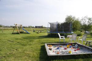 a play area with a table and chairs and a playground at Landhaus-Sutje-Deichblick in Böhl