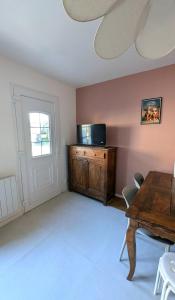 a dining room with a wooden table and a window at Les Misstinguettes in Hyenville
