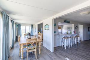 a dining room and kitchen with a table and chairs at 7847 - Summerset in Frisco