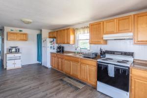 a kitchen with wooden cabinets and a stove top oven at 7847 - Summerset in Frisco