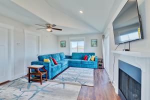 a living room with a blue couch and a fireplace at 4740 - August's Summer Place in Kitty Hawk Beach
