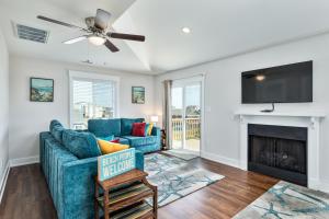 a living room with a fireplace and a tv at 4740 - August's Summer Place in Kitty Hawk Beach