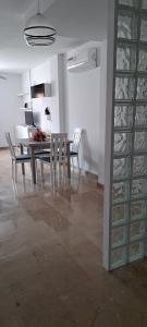a dining room and kitchen with a table and chairs at Arroyo Rechita in Cazorla