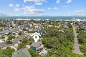 an aerial view of a residential neighborhood with a road and houses at 1090 - Catch Me N Corolla in Corolla