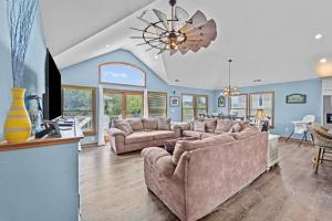 a living room with two couches and a ceiling fan at 1090 - Catch Me N Corolla in Corolla