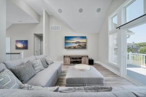 a living room with a couch and a table at 4918 - Stress Less in Kitty Hawk +26 photos