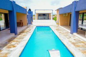 a swimming pool in the middle of a house at De Lux Villa in Bulawayo