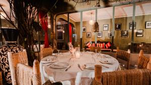 a dining room with a table with plates and candles at Le Bled Ferme in Marrakesh +73 photos