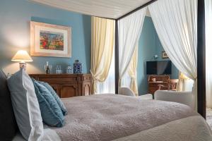 a bedroom with a bed with blue walls and curtains at Opera Boutique B&B in Florence