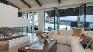 a living room with a couch and a fireplace at Crescendo Crest in Steamboat Springs