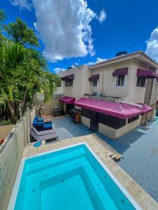 a swimming pool in front of a house at Haven Villa Retreat Jacuzzi Oasis in Mata los Indios