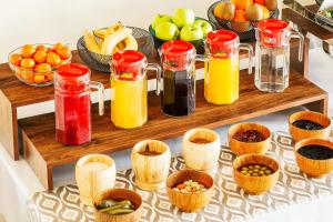 a group of jars of juice and fruit on a table at Grand Nur Hotel in Tashkent
