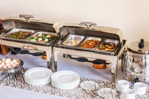 a buffet with two trays of food on a table at Grand Nur Hotel in Tashkent