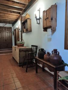 a room with a table and some pots on a wall at Casa Rural El Regajo Valle del Jerte in El Torno +53 photos