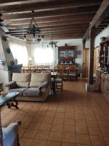 a living room with a couch and a table at Casa Rural El Regajo Valle del Jerte in El Torno
