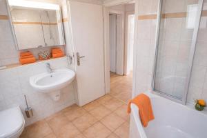 a bathroom with a sink and a toilet and a shower at Landhaus Thanner in Ofterschwang